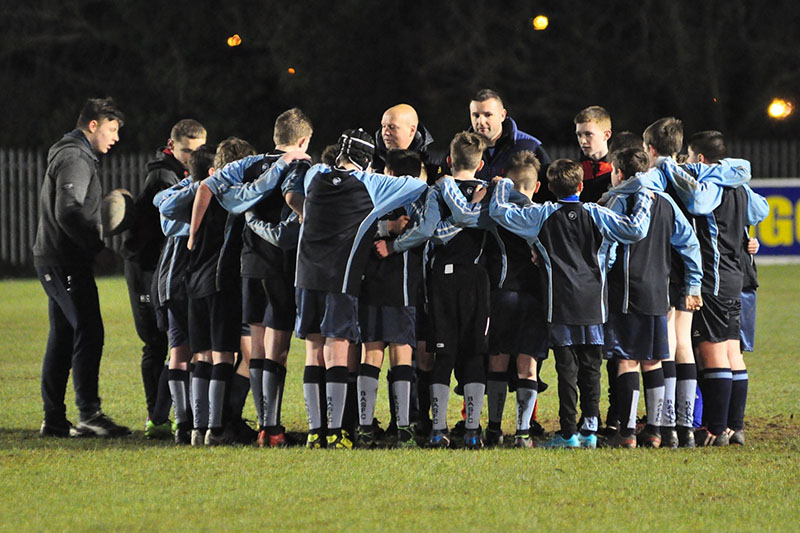 rugby youth team huddle