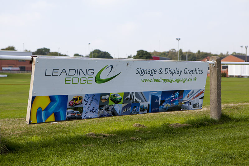 sponsorship hoarding at the side of a football pitch