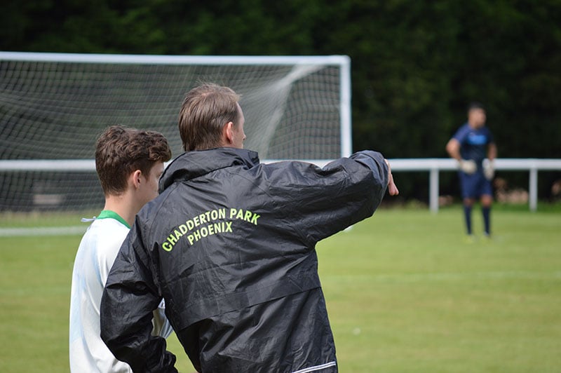 football coach explains tactics to player