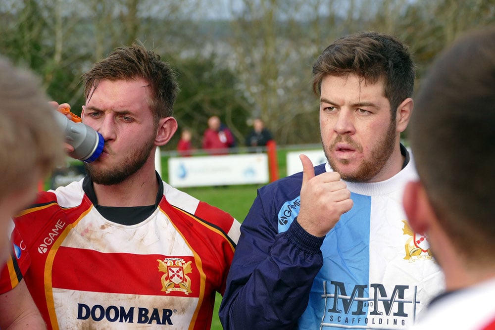 rugby player takes a drink during a match