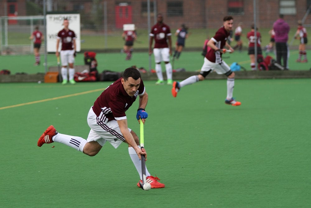 hockey player sprints during a match