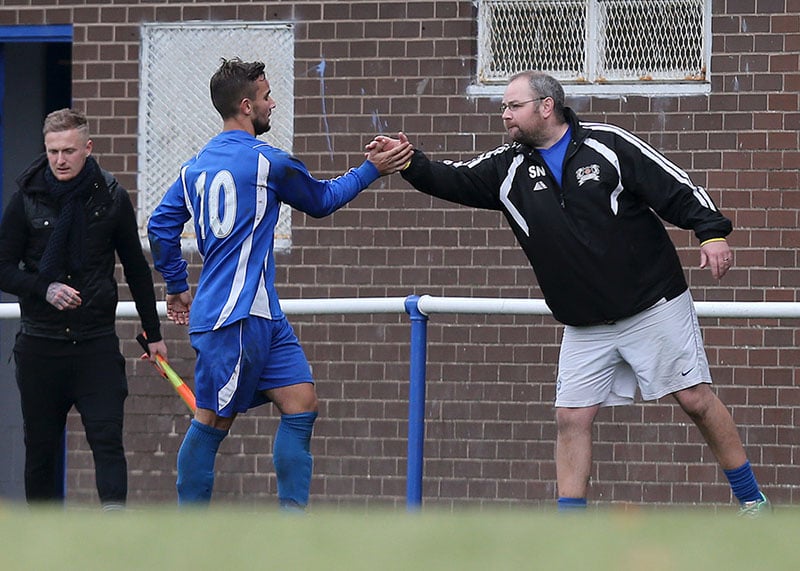 football coach high fives his player