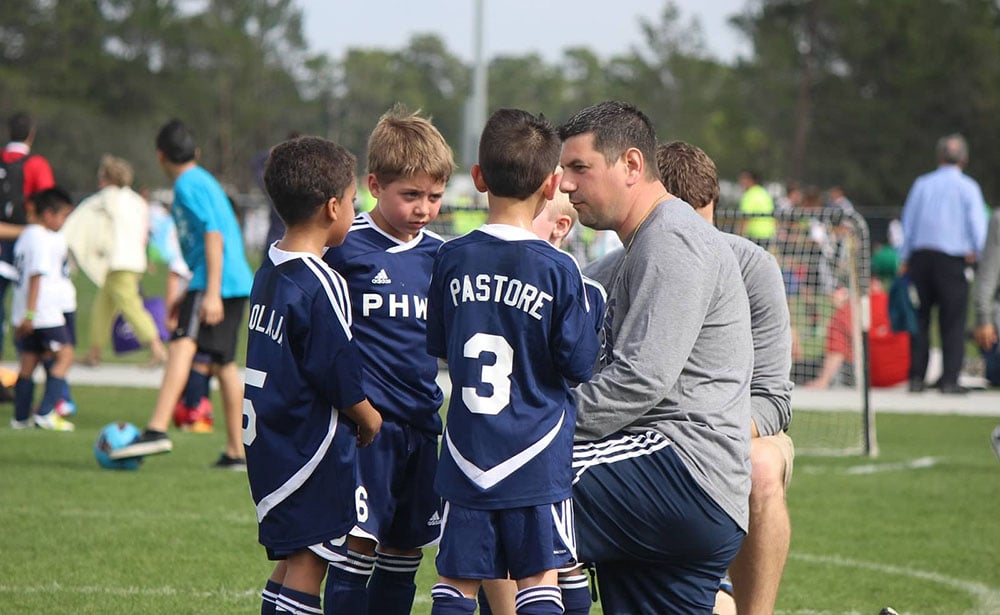 youth sports coach team huddle