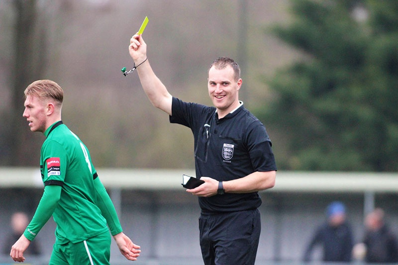 football referee gives a yellow card